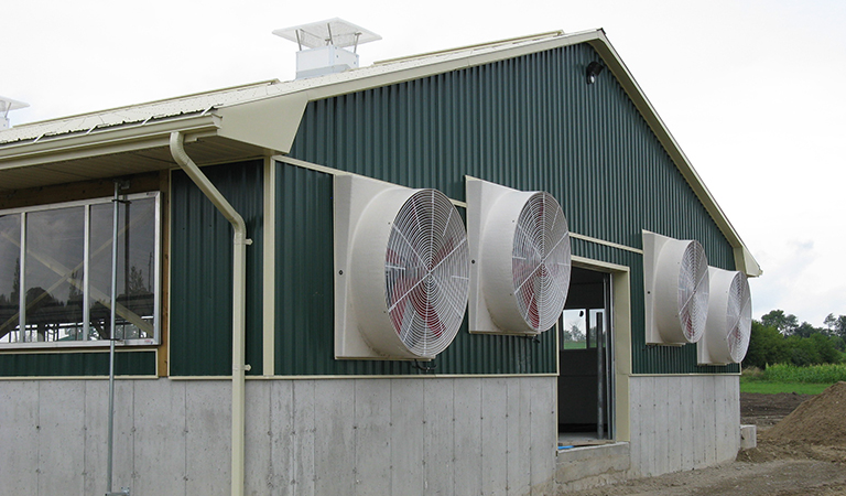Exterior of Barn Featuring Power Fans on the End